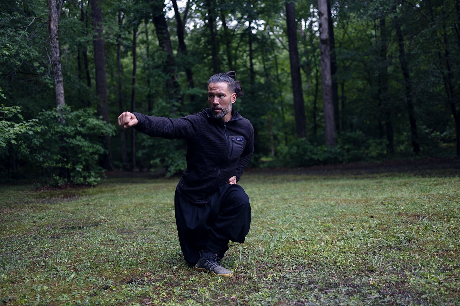 David Beaudry in the Dragon cross-back stance, back knee tucked behind his front calf, punching